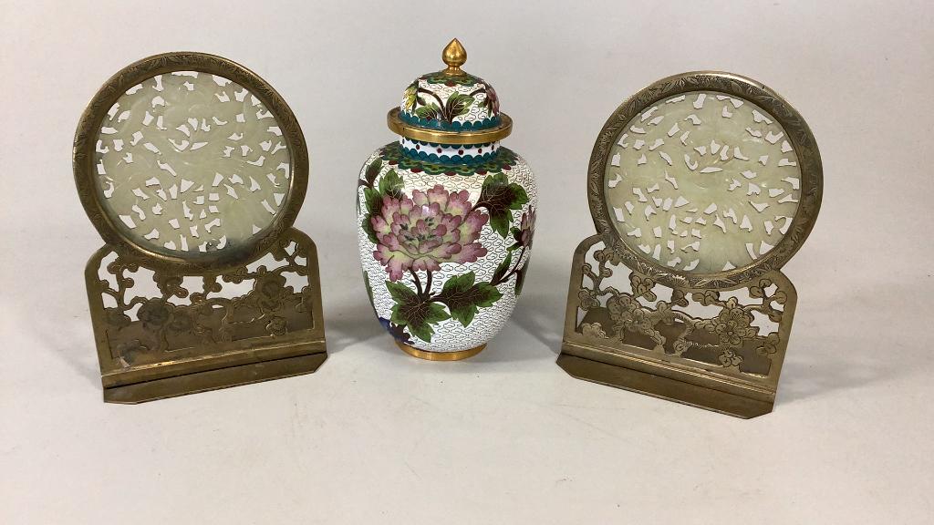 Brass and Jade Bookends, Cloisonné Urn: Chinese brass bookends with carved reticulated pale green panels depicting birds, pierced brass stands with foliate, 6 inch lidded enameled urn, florals on white ground, teal base