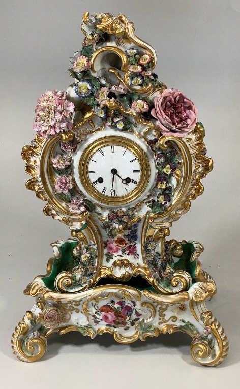Ornate Porcelain Mantle Clock: 13.5 inch Old Paris style clock with ornate florals, scrolls and gilt trim, enamel dial with Roman numerals, beveled glass door, unmarked works, with a matched 8 x 6 inch clock stand, a hand painted J