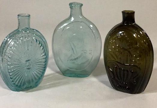 3 Blown Glass Flasks: Dark Amber 7 inch with cornucopia and basket of fruit to reverse pontil mark, 7 inch aqua green flask with embossed profile of Washington Father of his Country ( bubbles, slight flattened back, ) 6.5 