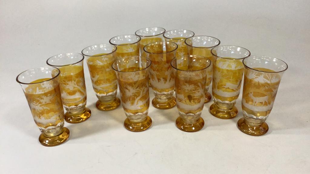 12 Bohemian Etched Glass Tumblers: 5.5 inches tall, stag and forest amber etched designs, minor rim chips Line Item # 13
