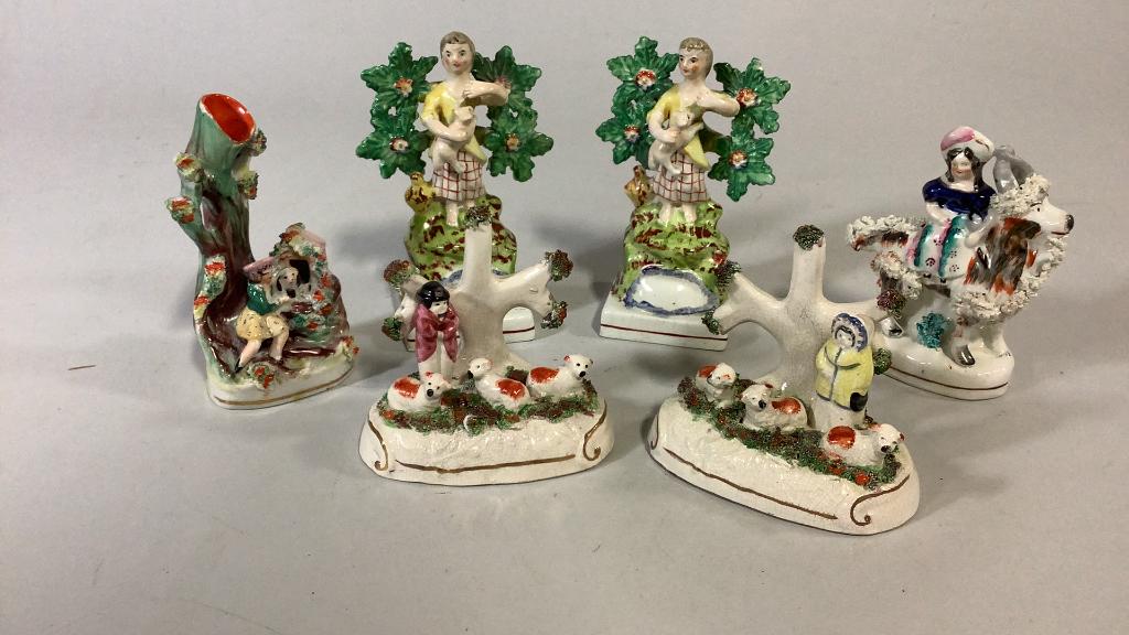 6 Staffordshire Figures: Pair 6 inch tall standing figures at tree, holding a dog, base stamped Walton, pair 4.5 inch figures at tree with dogs?, 5 inch spill vase woman holding a dog , 5 inch woman riding a goat
