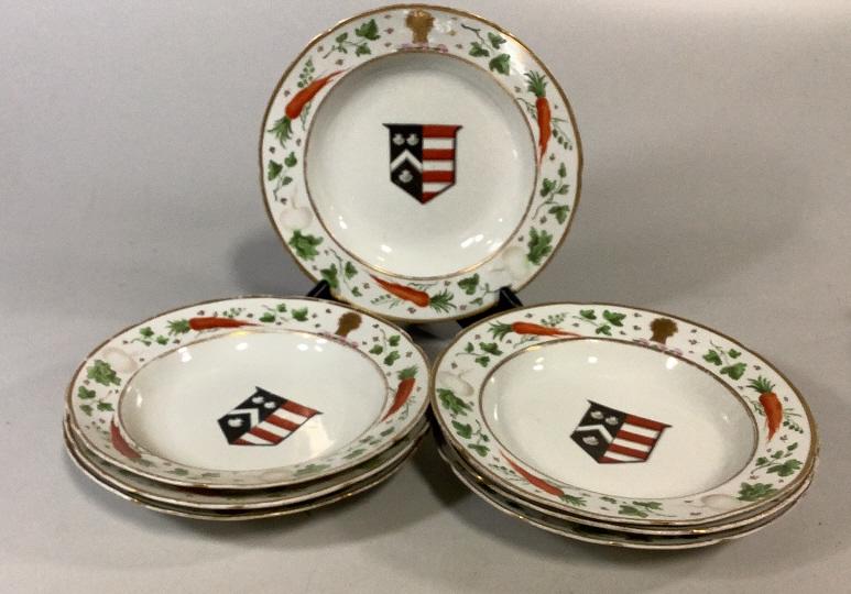 7 Armorial Rimmed Plates: 9 inch rimmed plates, border designs of carrots, turnips, sheaf of wheat, central banner with sea scollops on a blue and red flag, unmarked
