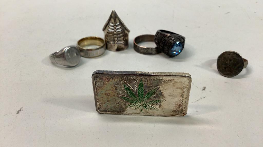 Troy Ounce Fine Silver, 6 Rings: Silver bar with Cannabis Leaf, sterling silver ring with unusual form, Class Ring with blue stone ( 2021), 3 rings no markings, 1943 Liberty dime mounted as ring