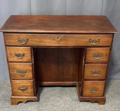 Georgian Mahogany Knee Hole Desk: Brass Bail pulls, bracket feet, dovetailed drawers, 2 drawers have been rebuilt, 41 tall x 39 wide x 19 deep