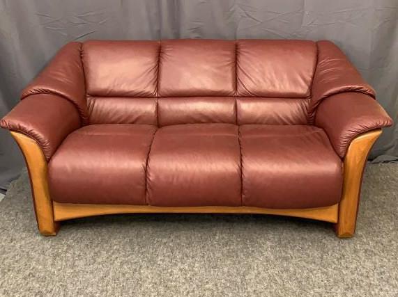 Ekornes Leather Loveseat: Red/brown leather in good condition, wood base, 3 seater, 69 inches wide, 19 inches to seat Line Item # 142