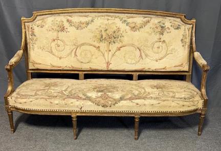 Swedish Gustat Gilded Sofa: 19th C Needlepoint upholstery, seat shows threadbear, rips and wear, brass tacks, carved accents,