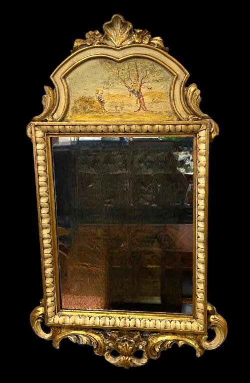 Spanish Rococo Style Trumeau Mirror: Vintage carved painted and gilt wood mirror, painted panel showing two boys in nature, shell crest, repair to scrolling, tag on back, 51H x 30W