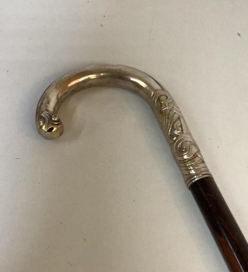 Silver Topped Rosewood Cane: 35 inch walking cane with curved handle chased design to tip and shoulder band, light wear as expected to hand grip, cane tip removed