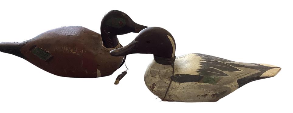 2 Duck Decoys: 15 inch hand carved Hadley Company decoy with weight, 14 inch hand painted decoy, unsigned, painted eyes, old leather strap at base, weight