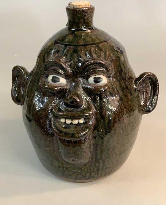 Clete Meaders Pottery Face Jug: Alkaline runny drip glaze, 10.5 inches, big ears, open comical features…dated 2003