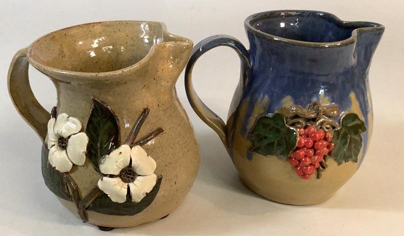 2 Wilford Dean Folk Pottery Pitchers: Georgia pottery, 7 inch Dogwood decoration 7 inch with blue runs to rim over grape vine, both signed, undated