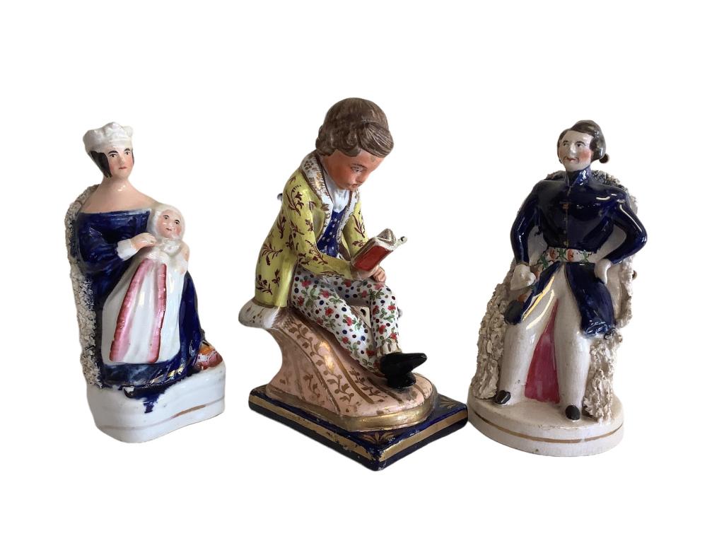3 Staffordshire Figurals: Queen Victoria and Prince Albert, 5.5 inches tall, Queen holds her first child, 6.5 inch seated figure of young boy in regal attire, Reading, Prince Bertie possibly ( first born son)