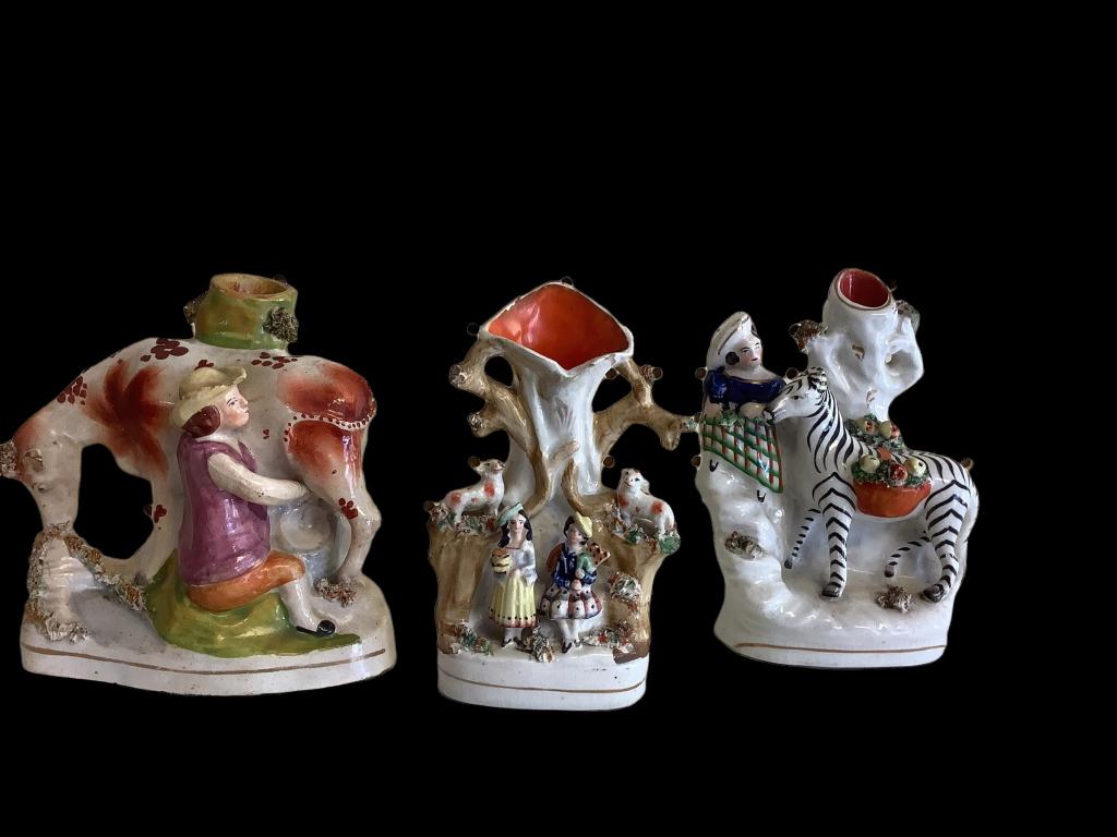 3 Staffordshire Figural Vases: 6.5 inch Highland Maid with Zebra, 6 inch lad milking a cow, 6 inch tree vase with sheep, seated figures * minor chips, paint rubs, stains
