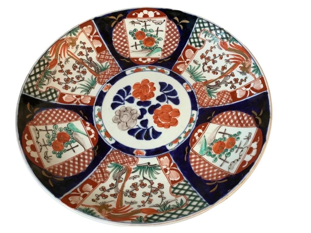Oversized Imari Charger: 18 inch rimmed Charger 6 panel decoration above a circular floral, in cobalt, iron red and green, reverse rim with clouds and bats in blue, double blue band foot rim.