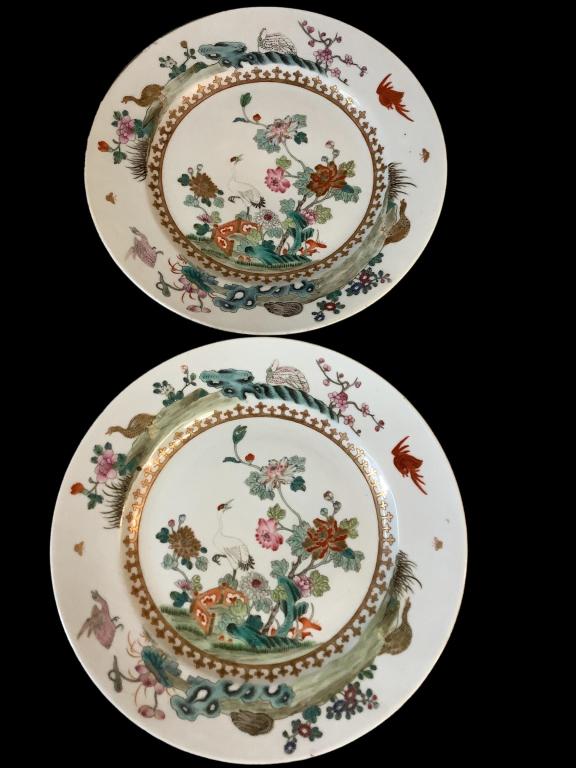 Two Famille Porcelain Plates: 9 3/4 inch shallow rimmed plates, hand painted cranes, budding branches, flying birds, gilt interior rim, reverse rims with detailed red bats, 4 character red seal stamp