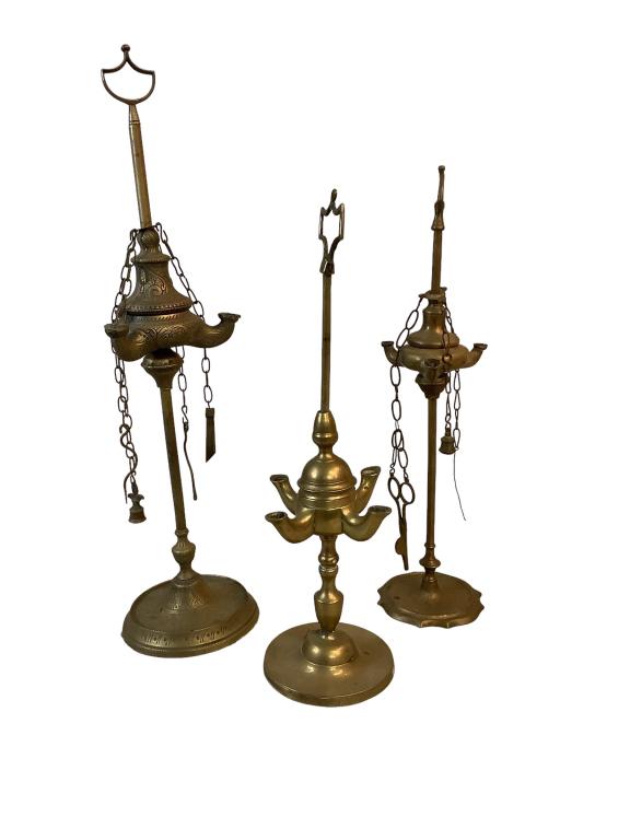 Three Vintage Brass Whale Oil Lamps: 16 to 22 inches tall, 4 spout lamp w/ no attachments, tallest 3 spout w/ overall chased Moorish design