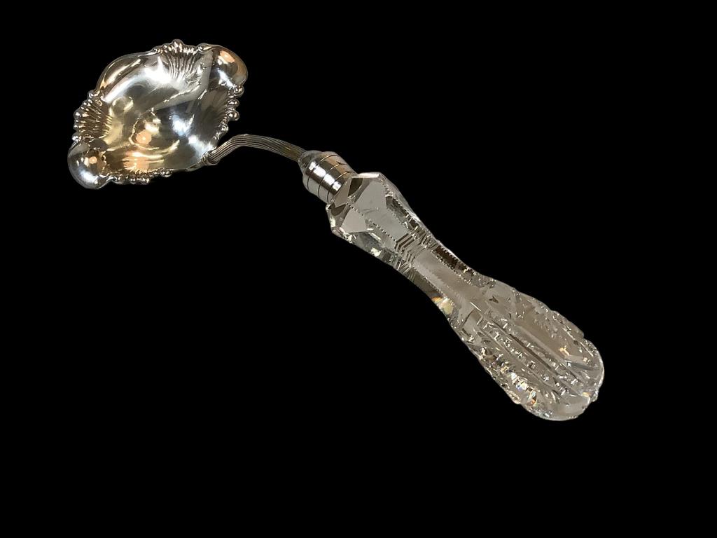 Pairpoint American Brilliant Cut Ladle: 14.5 inch ladle with a cut glass handle of 5.5 inches, silver plated reeded stem, 5 inch bowl, stamped Pairpoint