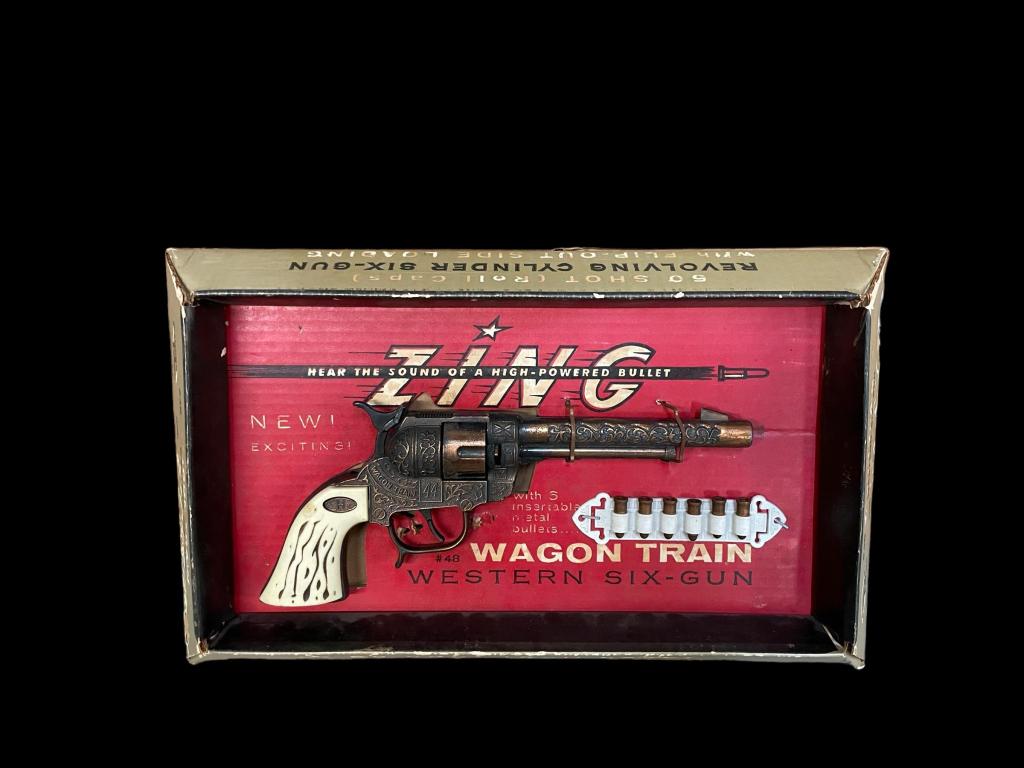 Leslie-Henry Wagon Train Western Six-Gun: Ca. 1950s, metal and plastic revolver with zing, 6 bullets on plastic clip #48, original box with two fasteners present, loss to box