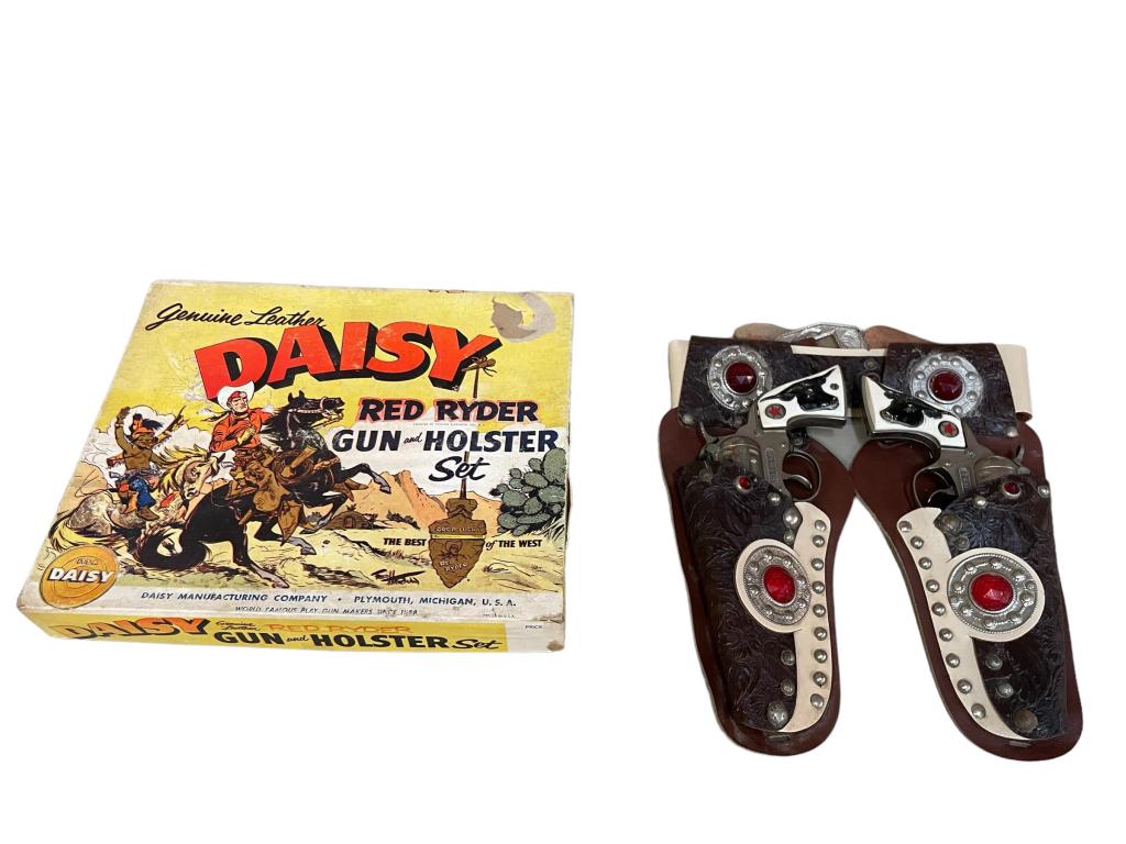 Daisy Red Ryder Gun and Holster Set: Genuine leather holster, 2 metal and plastic cap guns, leather needs cleaning, oxidation to metal on holster and guns, original box with age related wear and loss