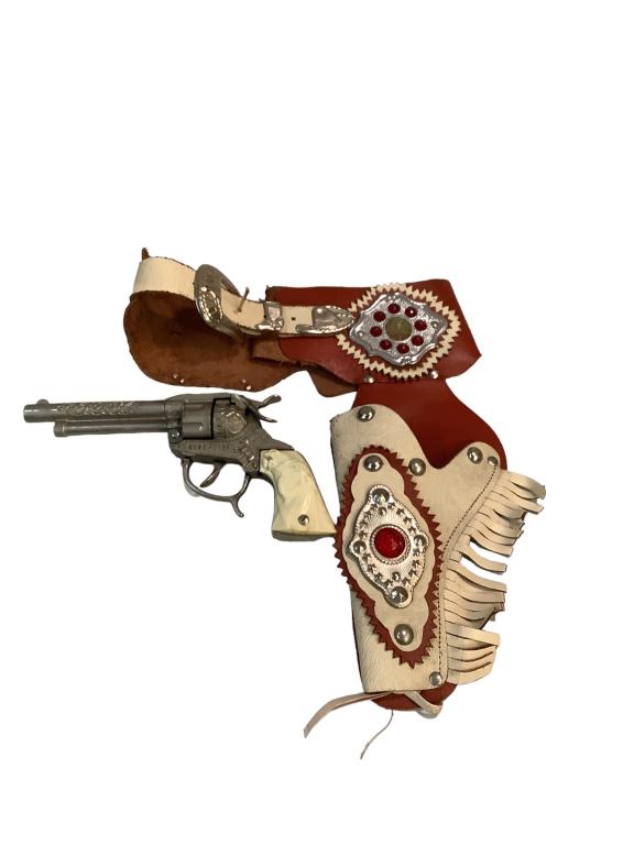 Vintage Gene Autry Cap Gun, SingleHolster: Break down cap gun with horse head grips, stamped Gene Autry with leather holster, studded and fringed, gun in nice condition trigger works freely, holster clean, both normal play wear