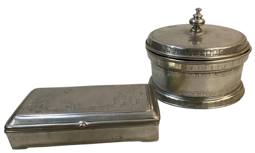 English Pewter Dresser Boxes: 4 x 7 flat top hinged lid box with castle scene to lid, 6 x 4; inch round lidded box, hammered design to rim, both with hallmarks undetermined