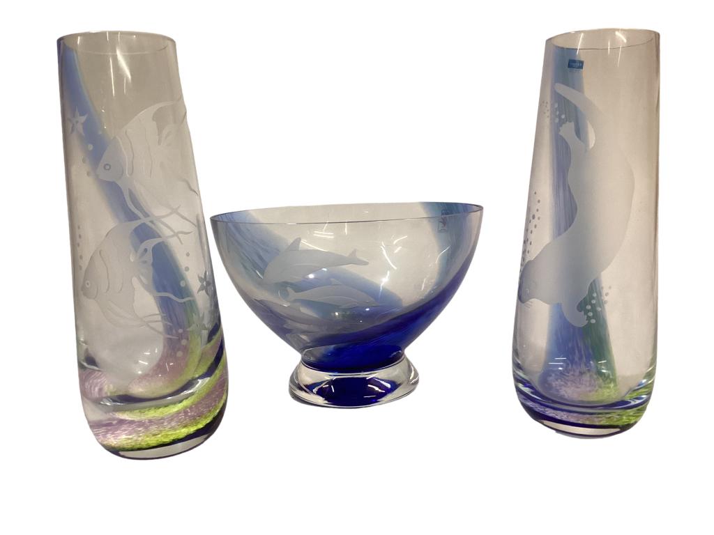 Three pieces Caithness Scotland Crystal: 8 inch diameter footed bowl, sea spays in blue, etched dolphins, 2- 9 inch tall vases, swimming fish, sea otters, all bearing paper labels 37 Good