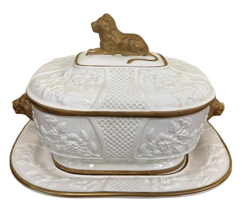 Mottahedeh Tureen and Underplate: 20th century, cream body with relief floral designs; gilt edges with three gilt lion figurals as handles, marked Mottahedah Museum Reproductions. 11.5 x 13 x 11..hairline to tureen, minor