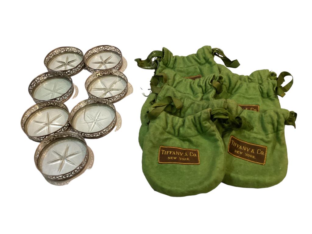 Seven Tiffany Sterling Coasters: 7- Tiffany and Co. Sterling rimmed coasters, star cut glass interiors, with branded felt dust covers Line Item # 6