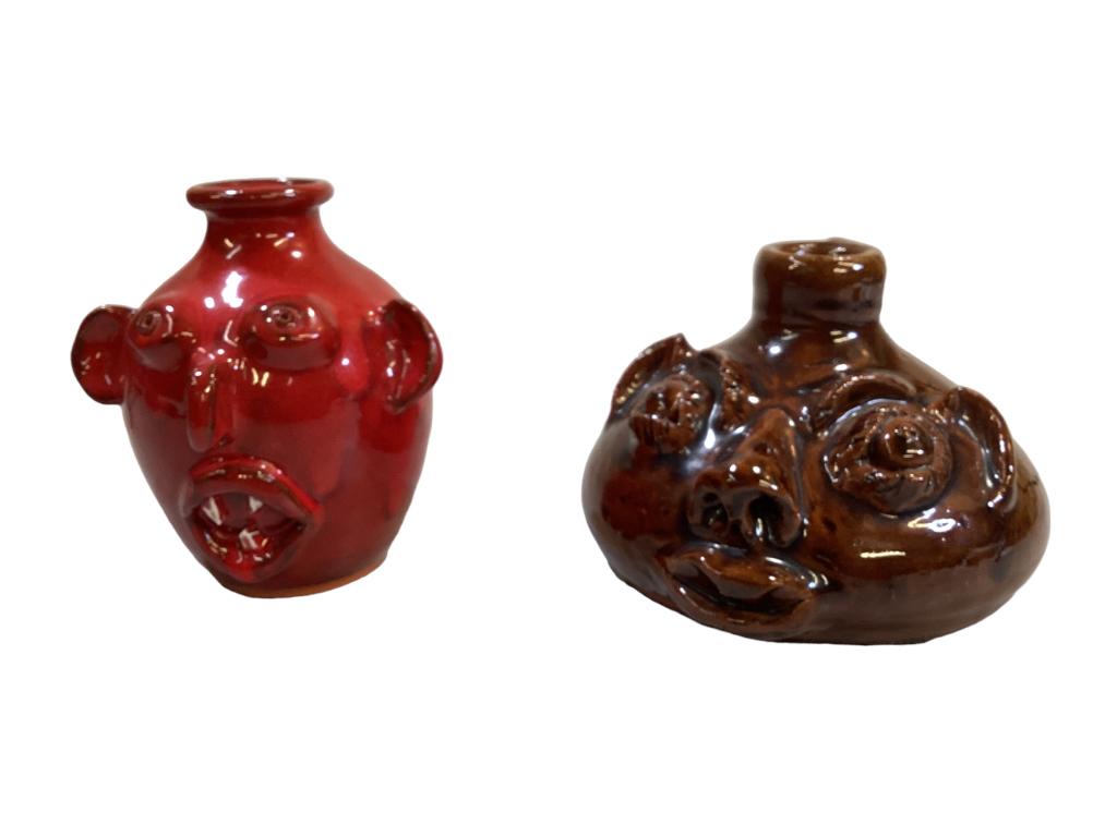 2 Face Jugs: Louis Brown squatty form face jug, 4.5 x 7 inches signed and dated 1991, inscribed For Don Cate, Laue Brewer Owens Pottery Red glaze face jug, 5 inches tall, big ears, chip teeth, signed and dated 98