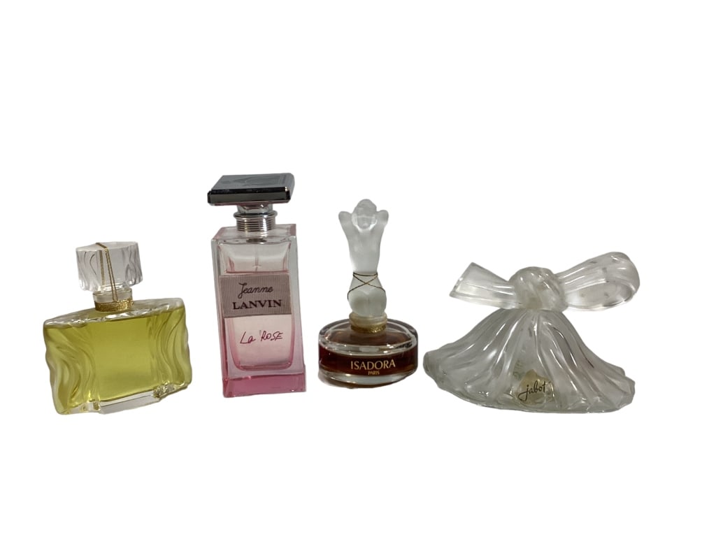 Four Parfume Bottles: Lalique bottle, Beautiful parfume, 1.oz size signed and #, Lanvin La Rose pink 3.3 oz bottle ( partial contents), Isadora 4.5 inch bottle with satin form kneeling nude, Jabot bow bottle ( chip to inte