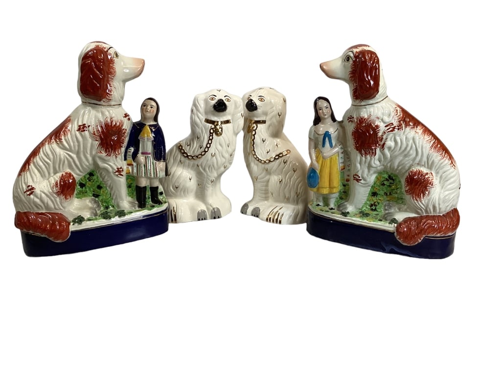 Two Pair Staffordshire Style Dogs: 12 inch tall reproduction pair of Guardian Spaniels each standing with a child, bright crisp color they are seated on a cobalt pedestal base, pair 9.5 inch Royal Doulton facing spaniels in ivory with 