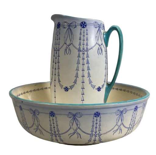Royal Doulton Washbowl and Pitcher: 15 inch diameter bowl with a 12 inch tall pitcher, decorated with bell flowers and bows, swags and blue trims Line Item # 76