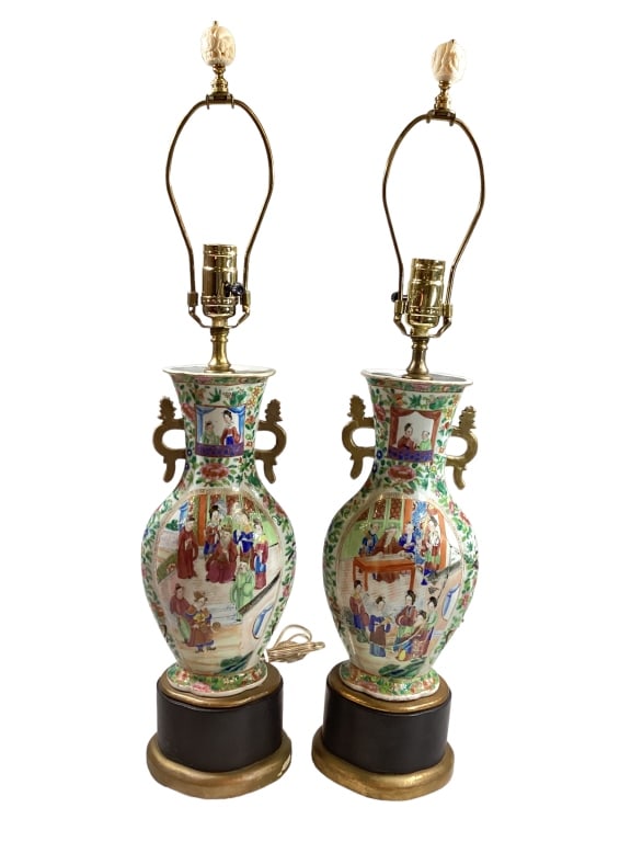 Pair Famille Porcelain Lamps: Rose Mandarin gourd form vases, oval panels each side, count scenes, foliate, gilt key handles. Mounted as lamps on painted wood bases.* one on right repaired Line Item # 15