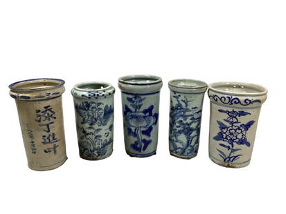 Blue and White Asian Articles: Five wall mount brush pots or vases, 7 to 7.5 inches tall, all in heavy clay with blue decorative designs, one as a poem or signed article, and all with vented bases. Some age stains, hairline to rims