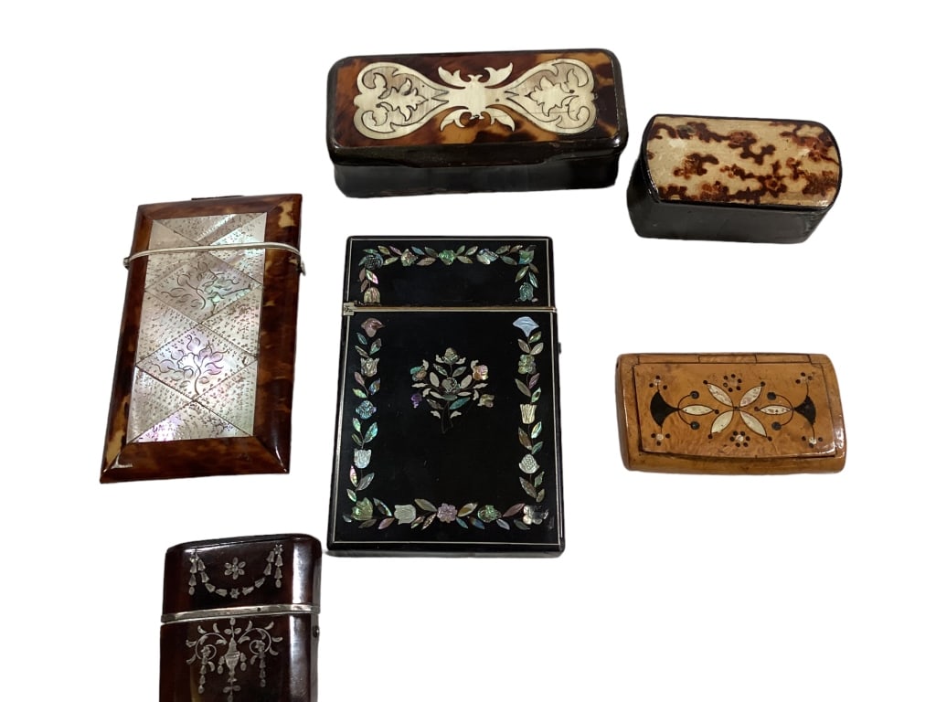 Six Pocket Boxes: Lacquered and inlaid flip top case, Shell and mother of pearl card case, 2.5 inch burl pill box with inlay top, 4 inch lacquered and bone inlay pill box, petite 2 inch flip top case with silver Inlay