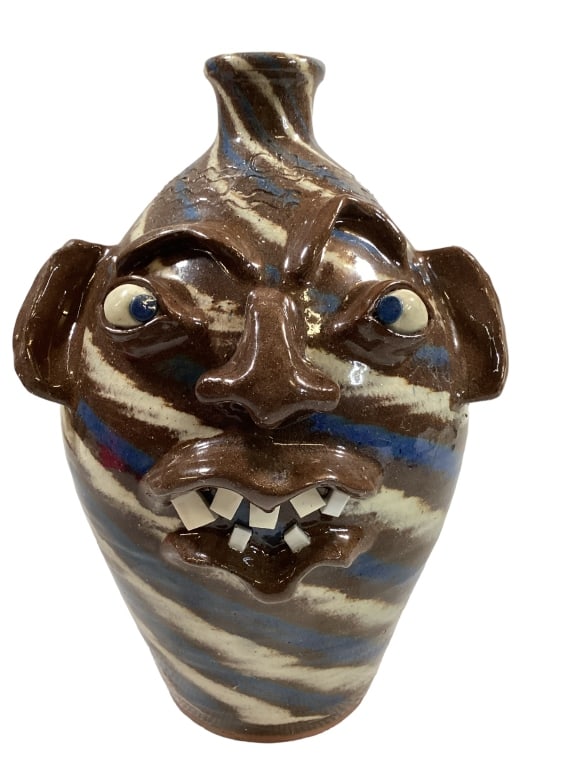 Charles Lisk Folk Pottery Face Jug: 14 inches tall, 2 color blue swirl ugly face jug, bug eyes, big nose and lips, chip teeth, single loop handle at neck, stamped CL with incised lines at collar, also stamped to base