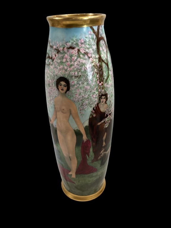 Limoges Hand Painted Vase: Artist signed vase depicting a scene of nude figure in a scenic depiction, flowering tree branches, Grecian influences 22 inches tall, tapered form, gilt rim and base decoration. * has been drilled