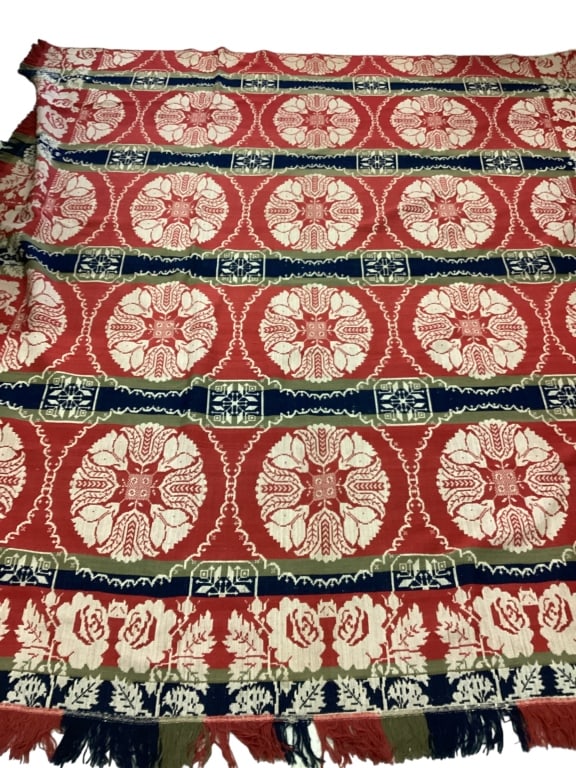 Coverlet: 102 x 86 woven jacquard coverlet in red, blue, green and cream colors, pin wheels, tulips, roses on border , label for Lebanon PA, Joseph Smith and Sons