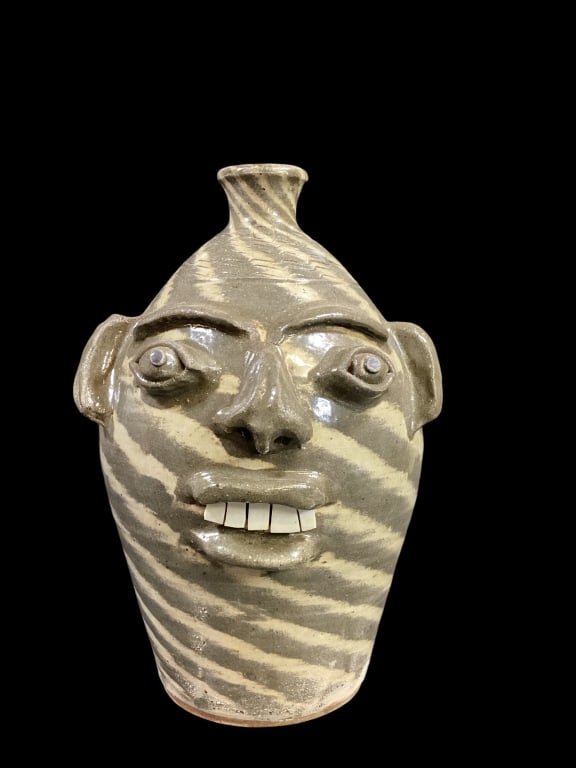 Charles Lisk Swirl Face Jug: Two tone swirl ugly face jug with bulging eyes, open mouth, chip teeth, loop handle, stamped CL at neck
