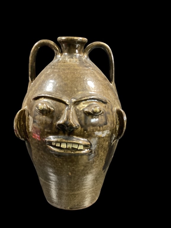 Charles Lisk Face Jug: Three gallon jug with alkaline glaze, glossy brown to green, protruding eyes, chip teeth stamped CL at neck