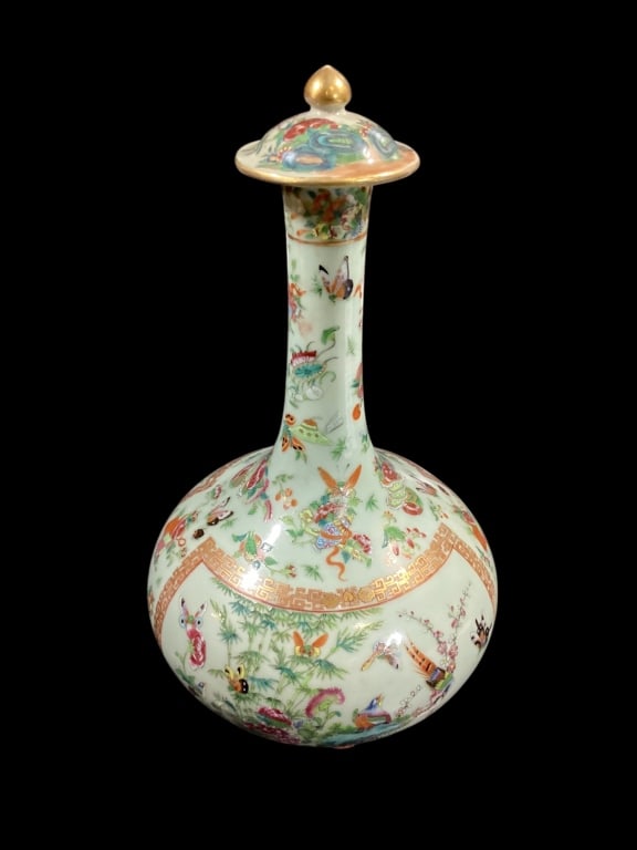 Famille Rose Porcelain Water Bottle Vase: 14.5 inch tall in Celedon green with 1000 butterfly pattern, bulbous body with tall tapered neck, opposing panel decorations, capped lid with gilt finial. Dry foot ring