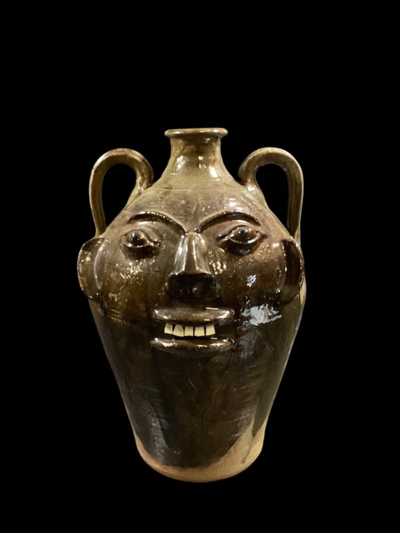 Walter Fleming Face Jug: Good Large size face jug, deep glossy alkaline glaze, forward facing flat ears, bug eyes, Chip teeth, double handles, rutile runs at handles, glaze skips and streaking. 18 inches tall, stamped Walter 