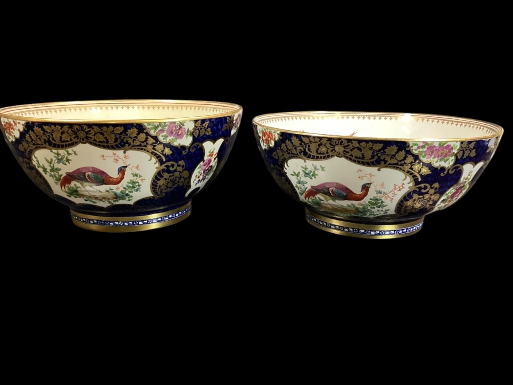 Near Pair Porcelain Punch Bowls: In the style of Worcester, with scrolled gilt flowers, exotic birds, panel decoration to exterior.cobalt ground, gilt rimmed foot, center with scattered florals on ivory, 10 inch diameter bowls..* one