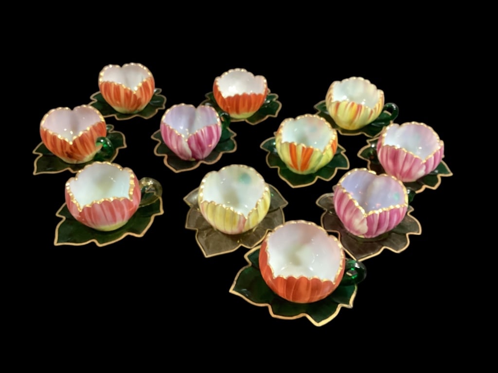 Set of Theresienthal Glass Cup And Saucer: Made in Bohemia by Theresienthal circa 1900. Lovely floral petal cups in cased white with varied color exterior. The sleazy shaped saucers are 5 inches. * one damaged cup