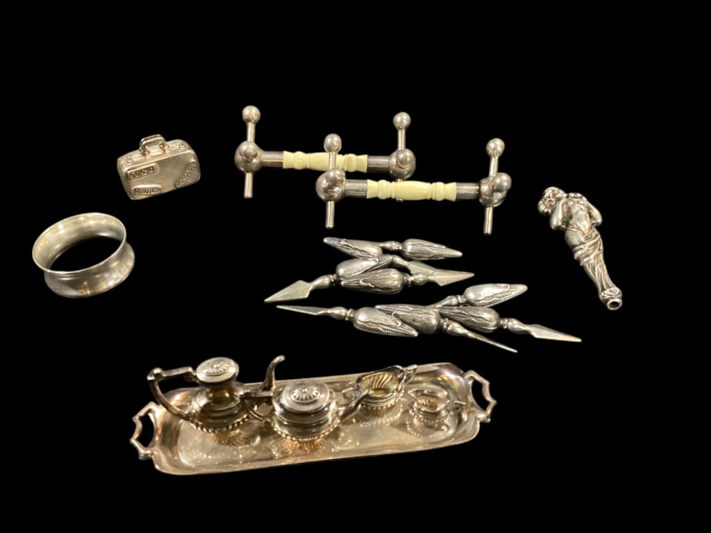 Sterling Oddities: Tiffany and Company, 1 3/4 inch Suitcase, five piece Miniature tea service, one napkin ring, pair British Silver knife benches with bone rests, set of eight Sterling ear of corn holders, three inch st