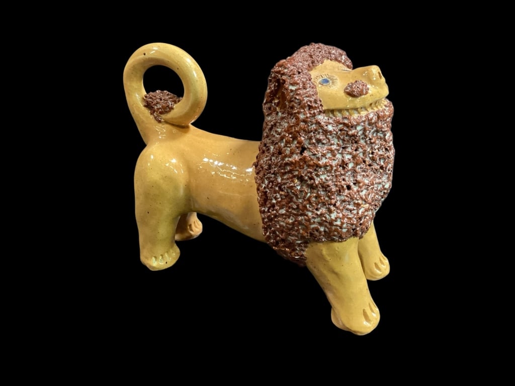 Billy Ray Hussey Curly Lion: Earthenware Shenandoah Lion, yellow glaze to body with curly reddish brown mane , curled tail. signed BH to Belly. 7 x 9 inches