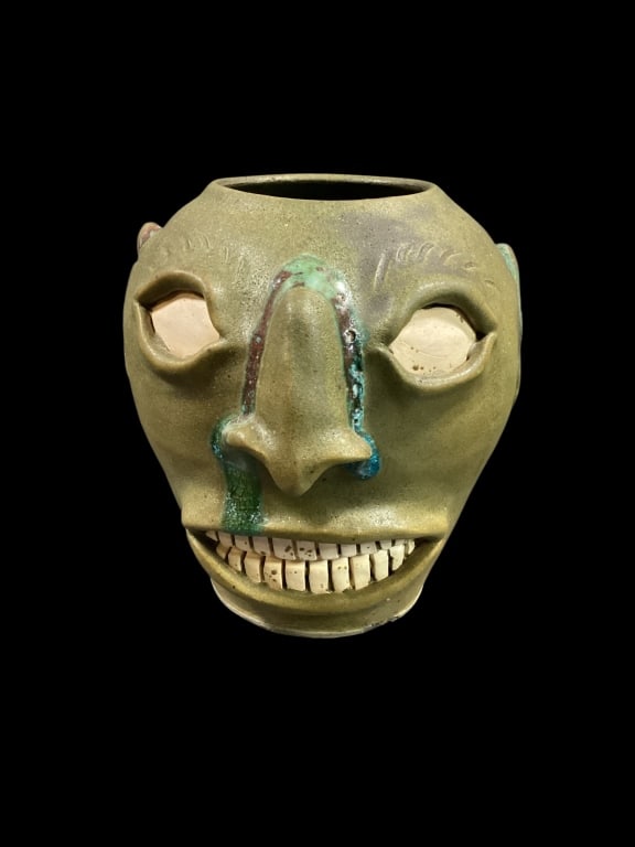 Billy Ray Hussey Face Jar: Flat glazed olive green with turquoise runs , 9 inch tall face jar vase, double row teeth, flat eyes, well formed ears, signed at base with XVI