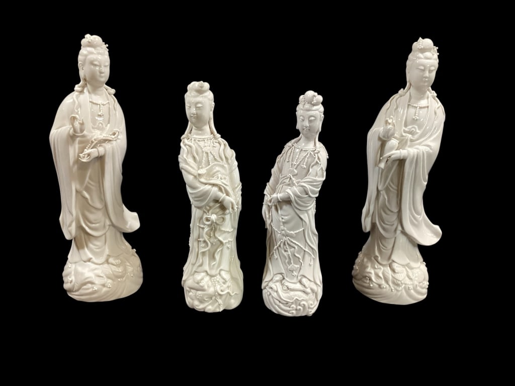 Four Blanc de Chine Figurals of Guanyin: Pair at 12 inches tall, one holding a rui, and one a vase, standing on flowing waves..smaller pair at 10 inches, each glazed with hollow base