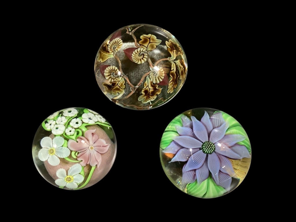 Three Orient and Flume Art Glass Paperweights: Larger 3.5 inch with botanical in clear glass#12/250, ..Pink and white cut flowers with floating pink base, date 1993, BEYERS lavender flower #13/250
