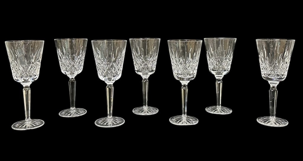 Waterford Crystal Tall Water Goblets: Seven 8.25 inch water goblets in the Lismore pattern, good condition overall with some surface grime and water spots, appear to be free of dishwasher wear, matched set with 2 different acid etched mar